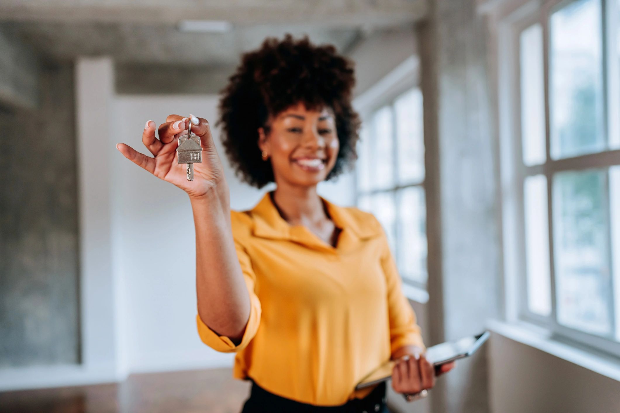 Real estate professional holding a house key